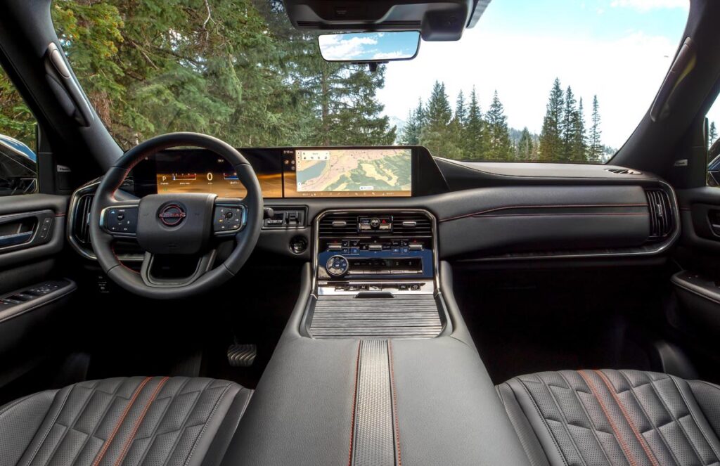 A pair of 14.3-inch displays and dashboard with knobs, buttons, and switches. Photo courtesy of Nissan