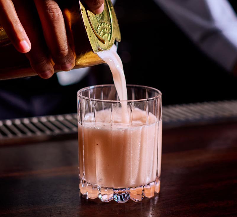 Enjoy the the Strawberry Gin Shrub, made with New Amsterdam Gin, strawberry and rhubarb pureĢe, house yuzu liqueur, and egg white. Photo courtesy of Le Colonial Naples