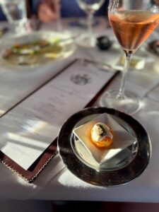 The Champagne & Caviar Friday menu features a tallow-fried tater tot topped with crème fraîche, chives, and Osetra caviar, paired with Crémant de Bourgogne Brut Rosé. Photo courtesy of D'Amico's The Continental 