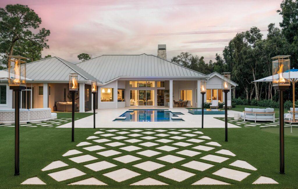 A linear pool lined with modern tiki torches leads from the home to a casita. Photo by Venjhamin Reyes