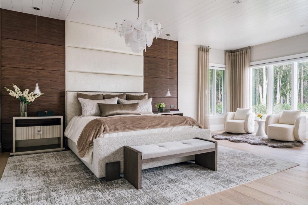 Elegant drapes and custom walnut paneling create sophistication in the primary suite. Photo by Venjhamin Reyes
