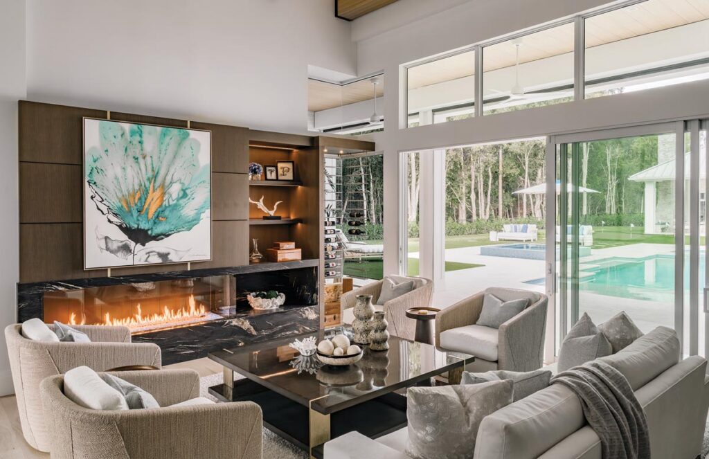 The great room exudes warmth with ceiling beams and a fireplace. Photo by Venjhamin Reyes